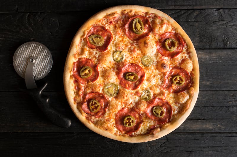 Families and friends enjoying pizza together at a community gathering